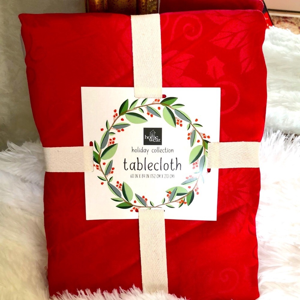 New red Christmas tablecloth with poinsettias.  Size 60” x 84”.  Seats 6-8.
